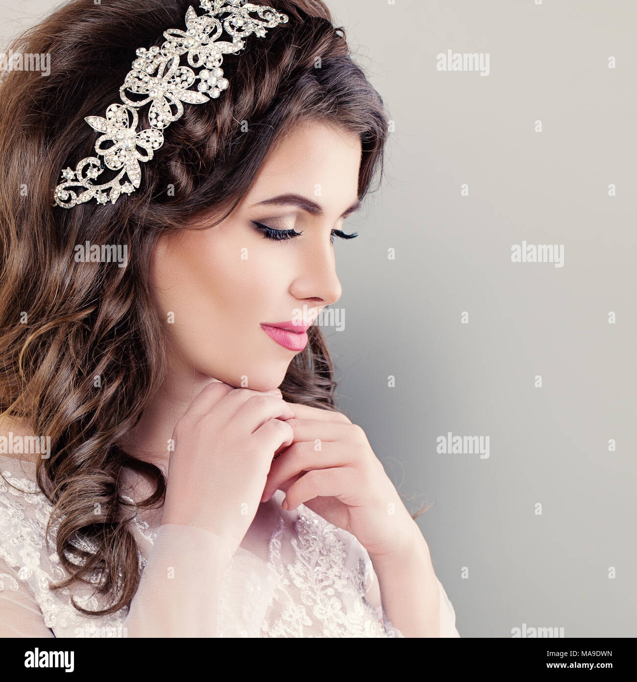 Beautiful Young Bride. Stylish Woman Fiancee with Bridal Hairstyle, Event Makeup and Jewelry Stock Photo
