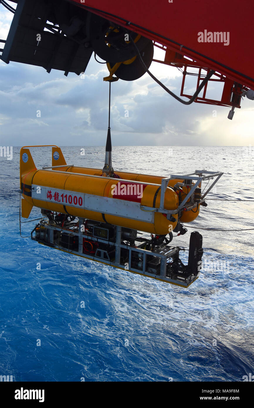 Aboard Dayang Yihao. 30th Mar, 2018. Photo taken on March 30, 2018 shows the unmanned submersible 'Hailong 11000' being put into the sea in the western Pacific Ocean. The unmanned submersible 'Hailong 11000' completed its first sea test in the western Pacific Ocean Friday. The submersible entered the 410-meter-deep sea area from the Chinese research vessel Dayang Yihao (Ocean No. 1) at 4:45 p.m. Credit: Chen Hao/Xinhua/Alamy Live News Stock Photo