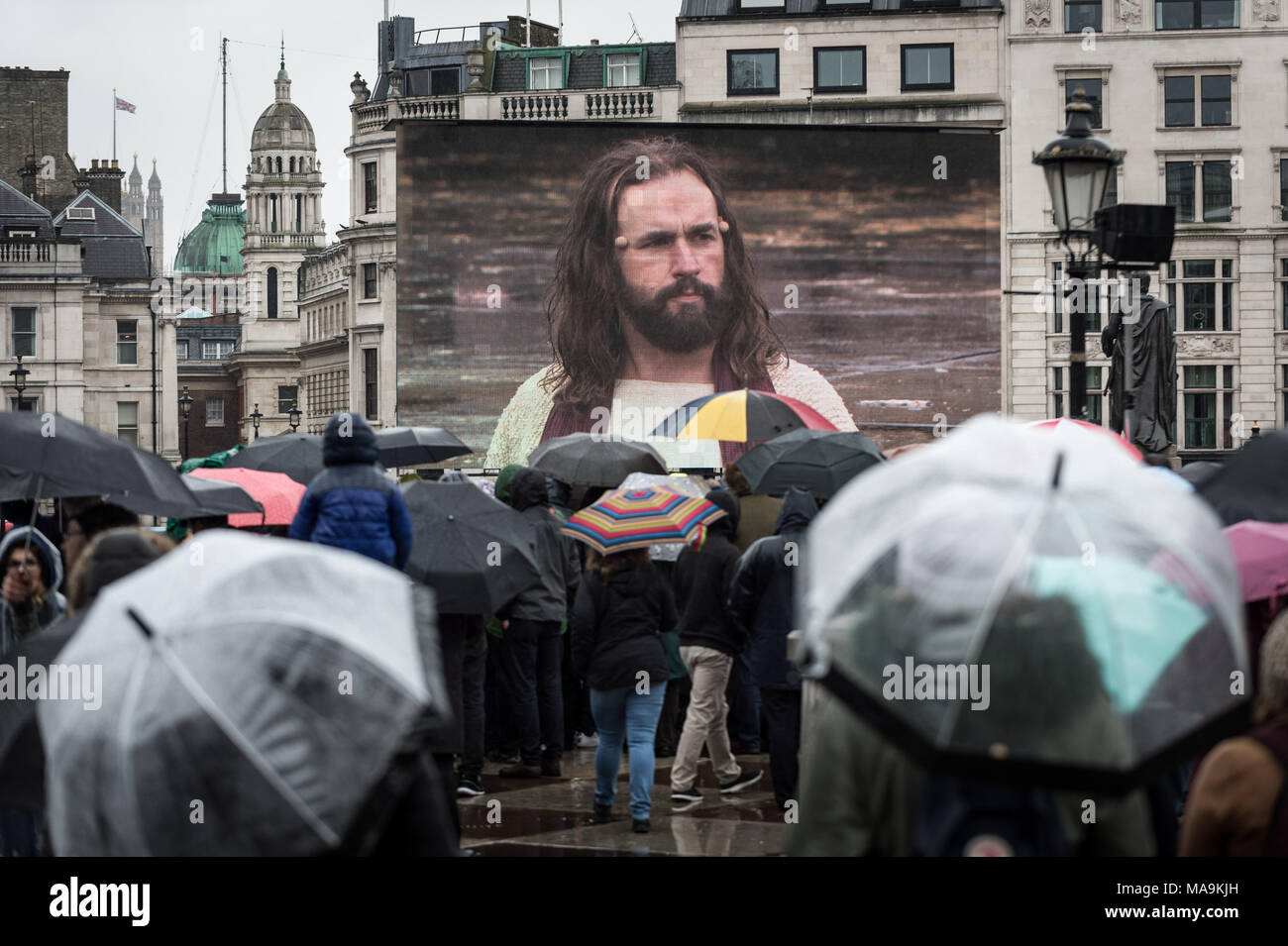 London, UK. 30th March, 2018. James Burke-Dunsmore as Jesus in the annual open-air performance of 'The Passion of Jesus' by the Wintershall Players on a rainy Easter Good Friday bank holiday in Trafalgar Square. Credit: Guy Corbishley/Alamy Live News Stock Photo