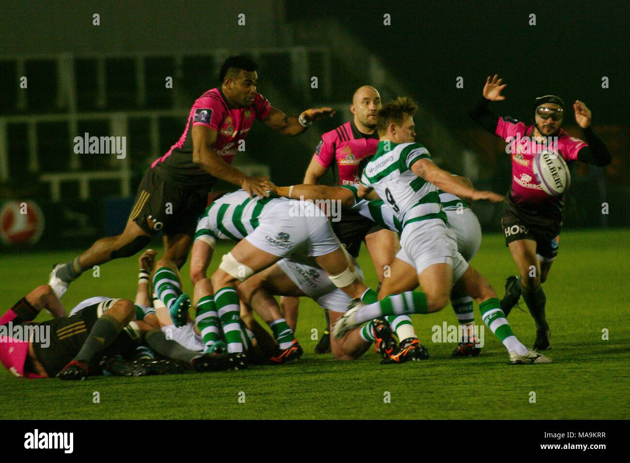 Newcastle upon Tyne, England, 30 March 2018. Sam Stuart, scrum half for Newcastle Falcons, kicking the ball. Brive scrum half Florian Cazenave is trying to charge the kick in the European Challenge Cup quarter finals at Kingston Park. Credit: Colin Edwards/Alamy Live News. Stock Photo