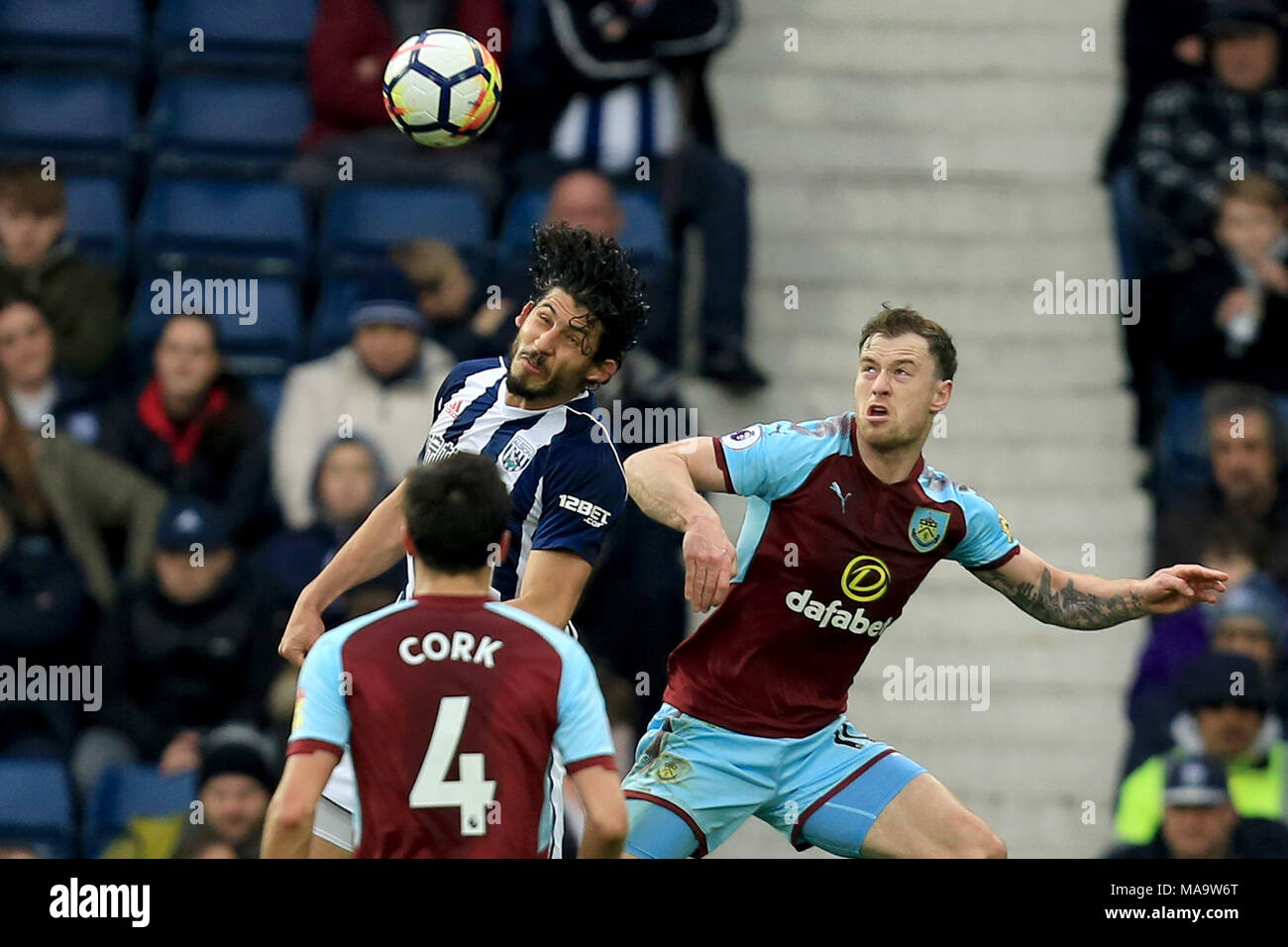 West Bromwich , UK, 31 Mar 2018. Ahmed Hegazy of West Bromwich Albion rises for a header with Chris Wood of Burnley. Premier League match, West Bromwich Albion v Burnley at the Hawthorns Stadium in West Bromwich on Saturday 31st March 2018. This image may only be used for Editorial purposes. Editorial use only, license required for commercial use. No use in betting, games or a single club/league/player publications. Pic by Paul Roberts/Andrew Orchard sports photography/Alamy Live news Stock Photo