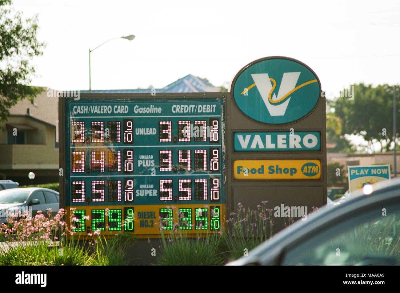 Price sign showing high gasoline prices at a Valero gas station in the San Francisco Bay Area, Concord, California, with an automobile approaching the station visible in the foreground, September 8, 2017. () Stock Photo