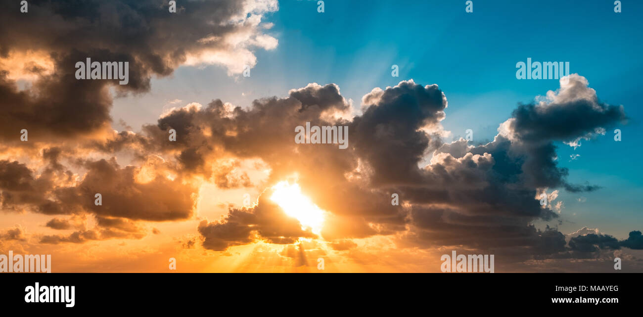 sunset sky - scenic sky and cloudscape - sunshine through clouds Stock Photo