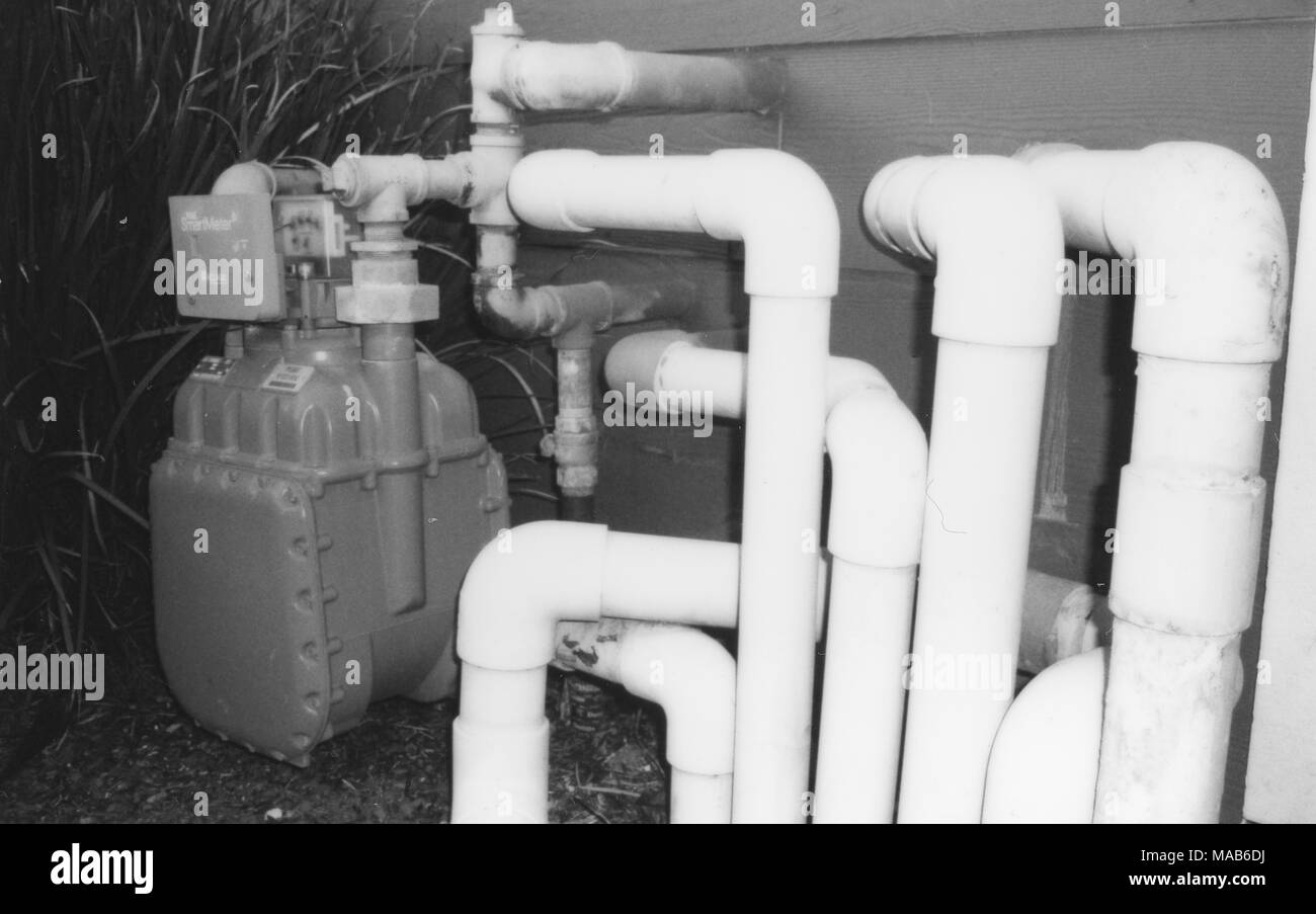 Starkly lit, black and white image of a maze of natural gas pipes leading to a Pacific Gas and Electric (PGE) smart gas meter, part of a smart grid program, Dublin, California, February 2, 2018. () Stock Photo