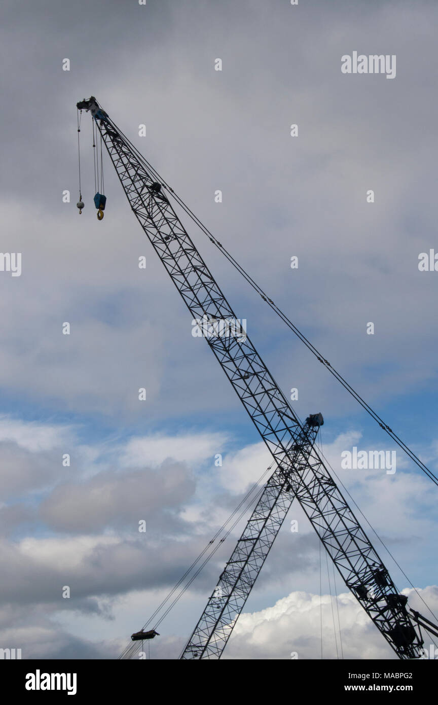 Construction cranes and cloudy sky on the Seattle,Washington waterfront. Stock Photo