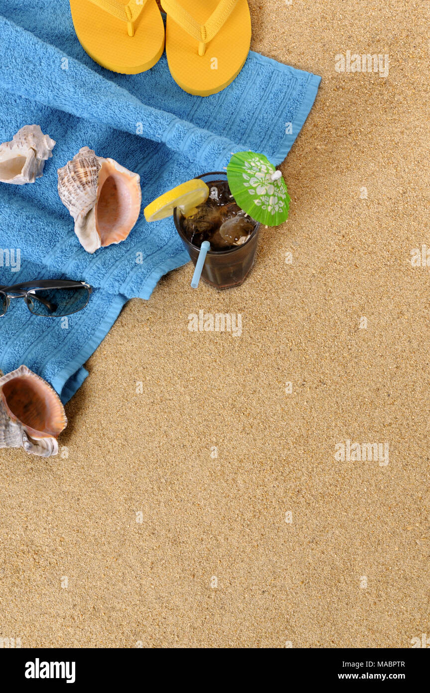Beach background with towel, glass of iced cola and flip flops. Space
