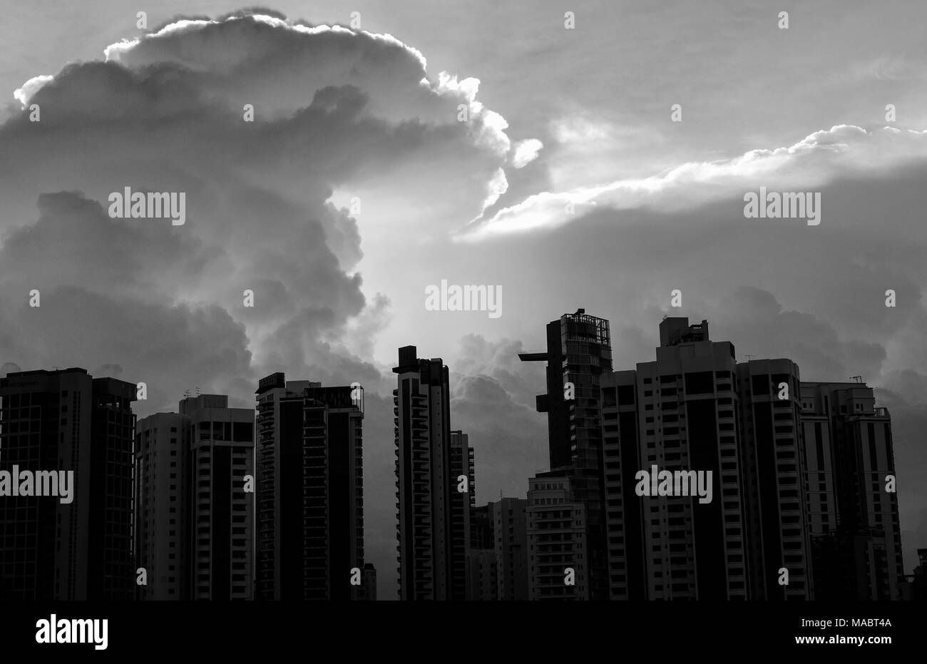 Amazing photo of sun shining through the clouds above the city skyline (black and white)) Stock Photo