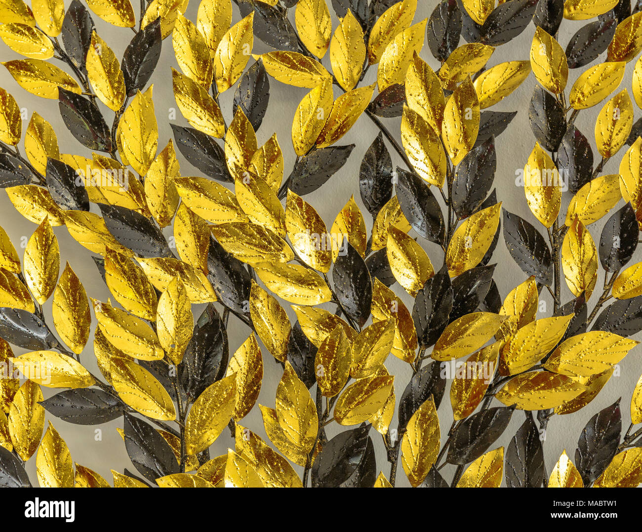 Close up Gold and black artificial leaf on wall Stock Photo Alamy