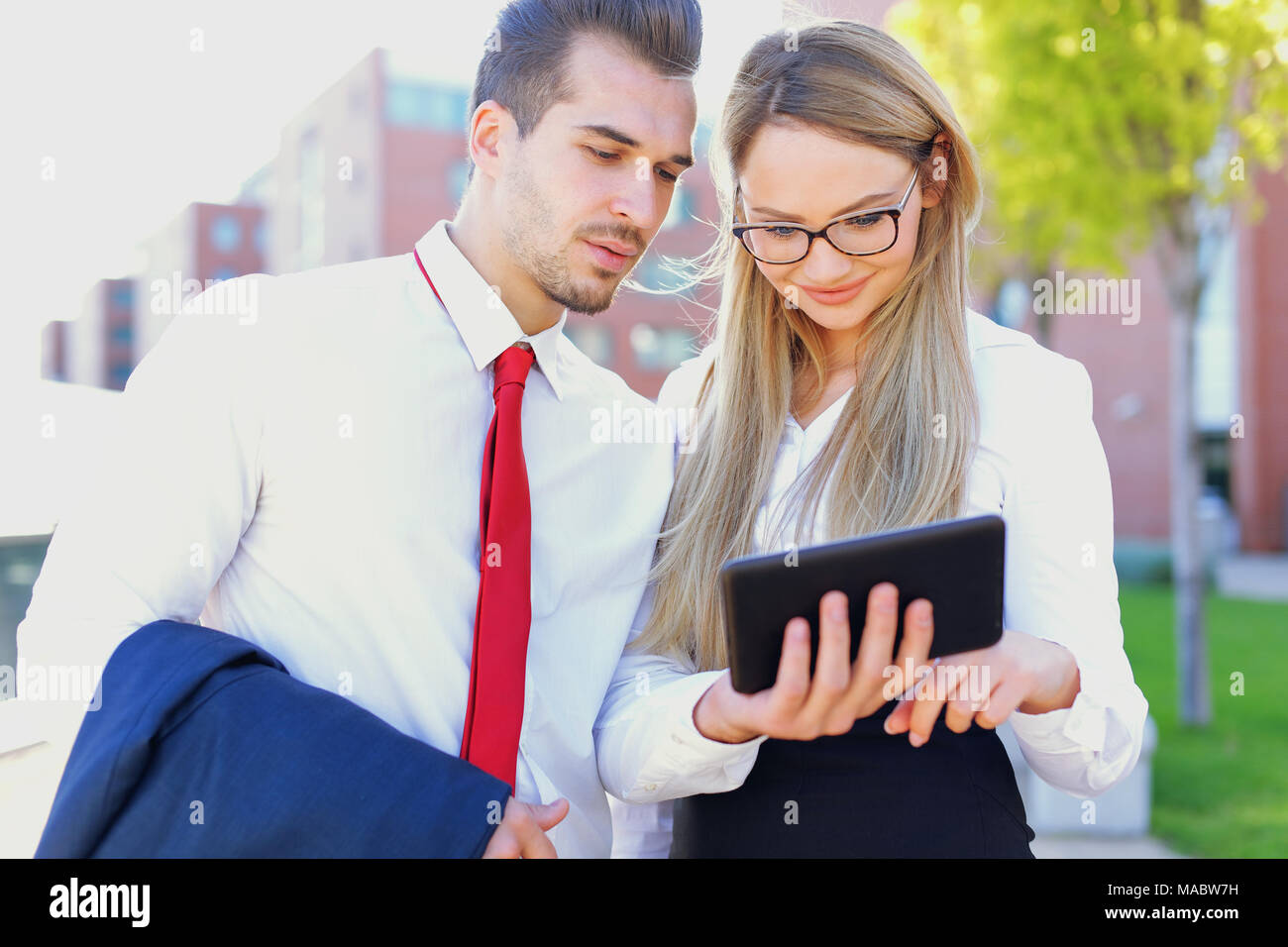 Young ameriacan businesspeople using digital tablet outdoor Stock Photo