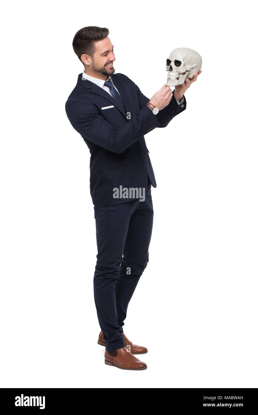 Businessman holding skull and smile, business rivalry concept, isolated on white Stock Photo