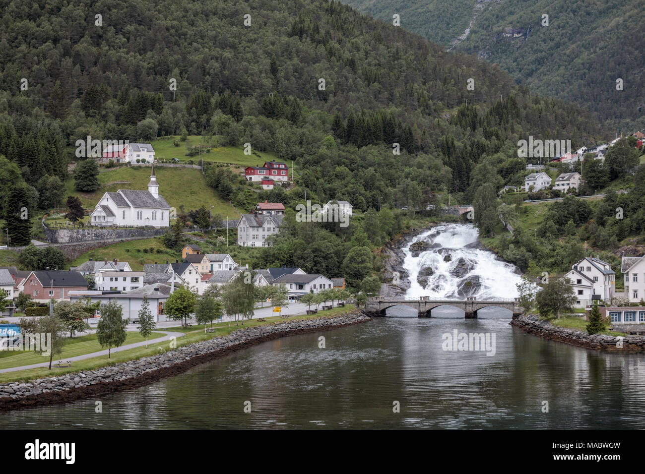 Hellesyltfossen, a beautiful waterfall that divides the village of Hellesylt (Norway) into two parts. Stock Photo