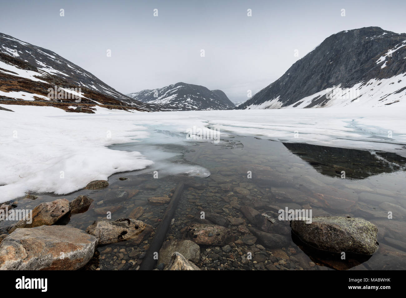 Djupvatnet Lake, surrounded by mountains, partly frozen Dalsnibba mountain, More og Romsdal, Norway Stock Photo