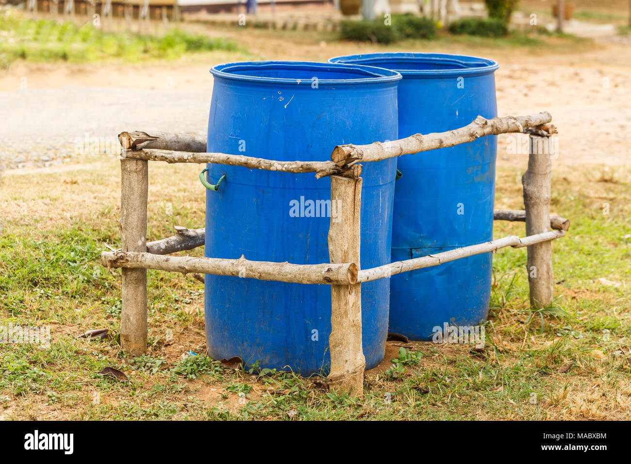 Two Blue Trash bins in wooden fence Stock Photo Alamy