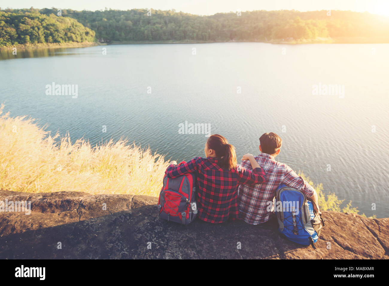 Young Backpackers Young backpackers enjoying with nature view. Couple adventure lifestyle ...