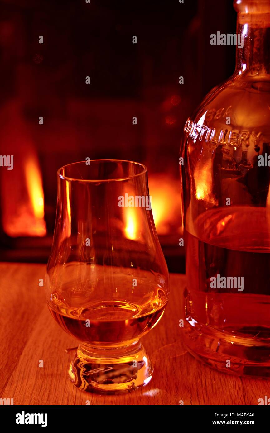 whisky glass and wooden fire Stock Photo