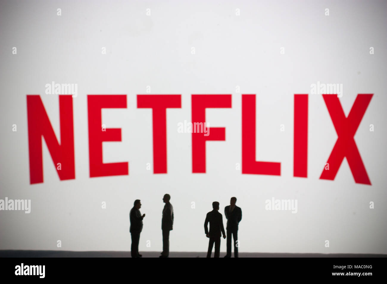 Netflix logo with models of people in foreground Stock Photo