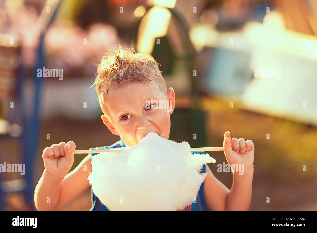 Young boy eating candy floss Stock Photo Alamy