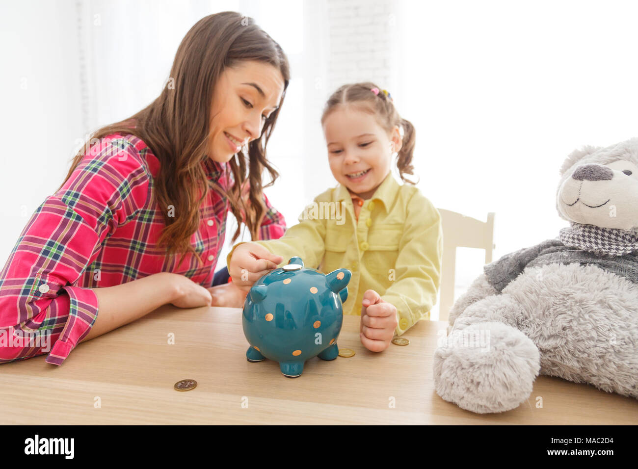 Mother teaches her daughter to save money Stock Photo - Alamy