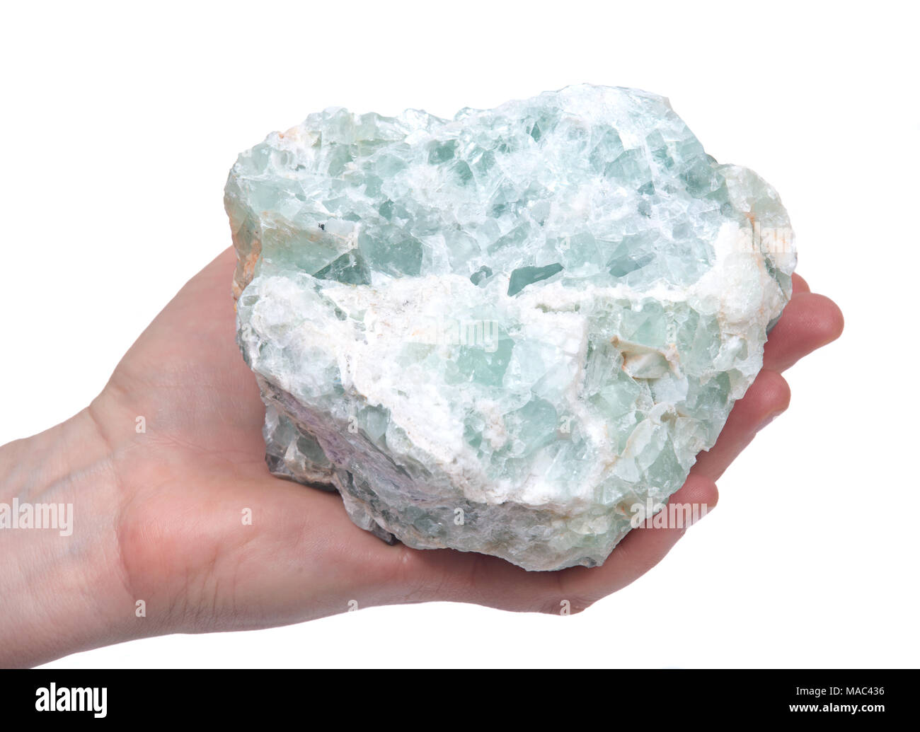 Woman's hand holding raw green apophyllite cluster isolated on white background Stock Photo
