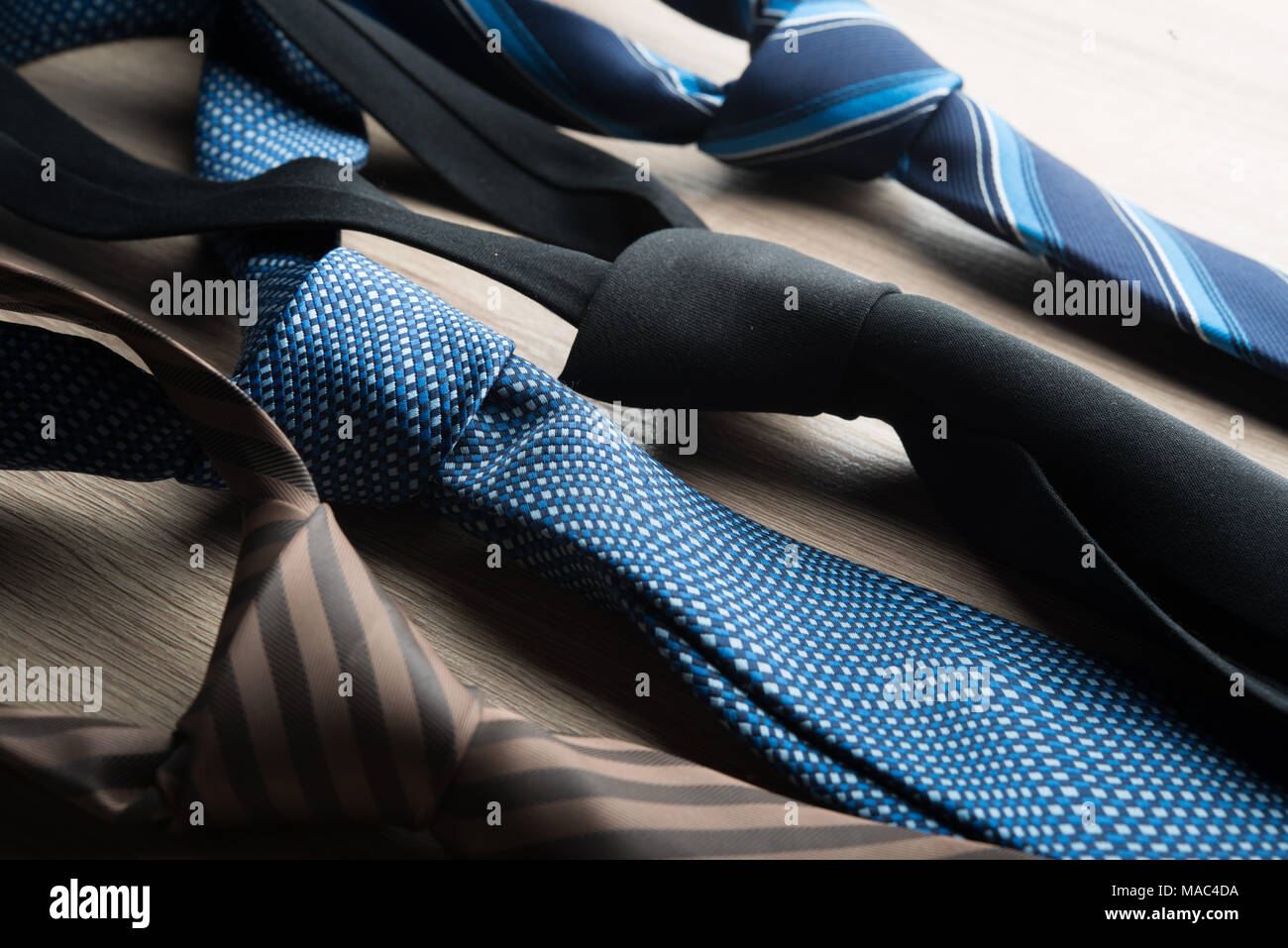 Silk neck ties on wooden background. Stock Photo