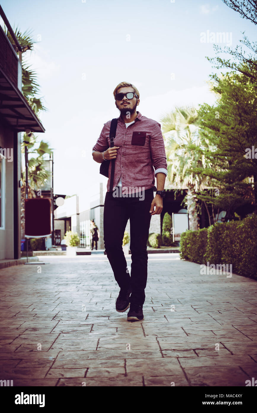 Portrait of handsome hipster man in jeans clothes and sun glasses ...