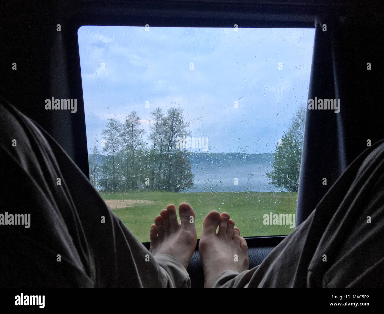 Chilling in the camper van during rain at the lake side Stock Photo - Alamy