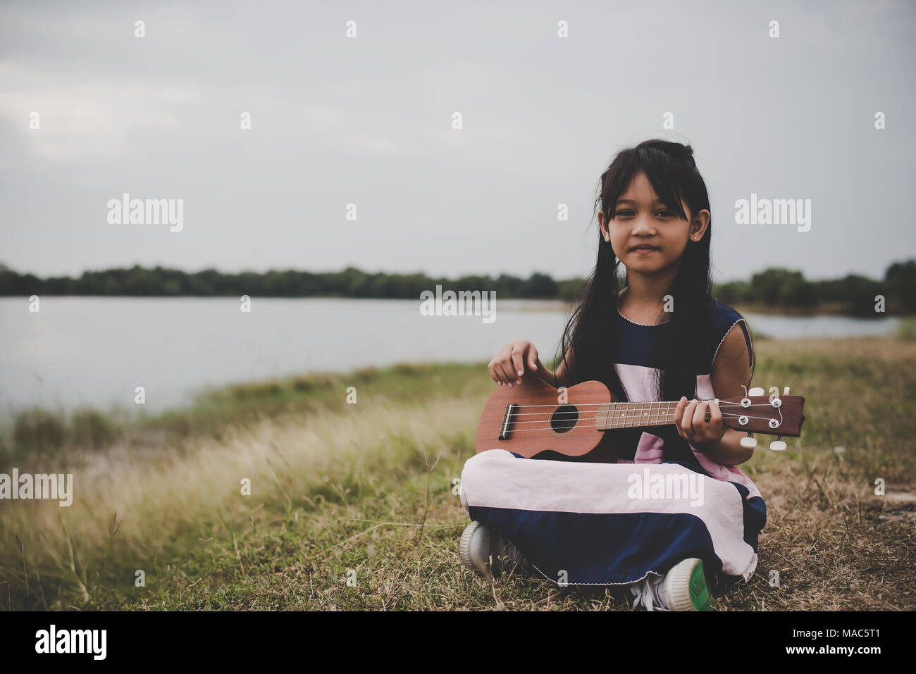 Asian girl ukulele guitar outdoor hi-res stock photography and - Alamy