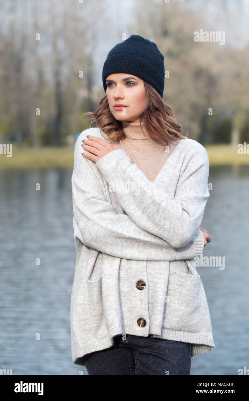 Beautiful Woman Fashion Model Wearing Black Cotton Hat in Cold Park Outdoors Stock Photo