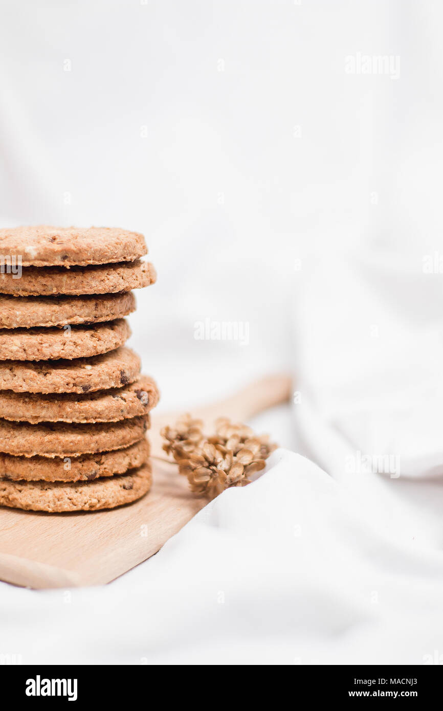 Sweet homemade cookies on a wooden board and white background Stock Photo