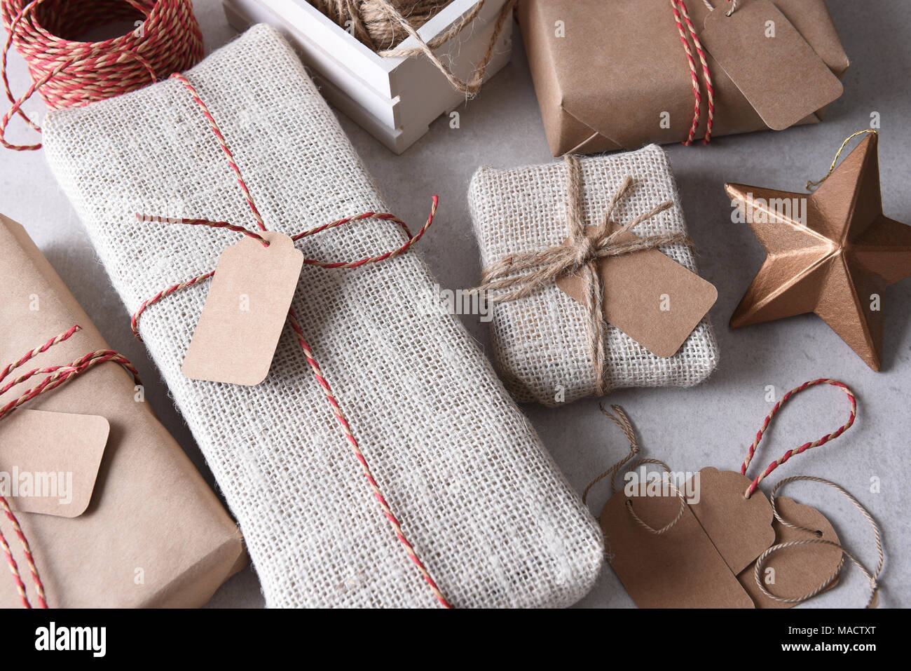 Wrapping Christmas Presents. High angle shot of a group of fabric and paper wrapped presents. Stock Photo