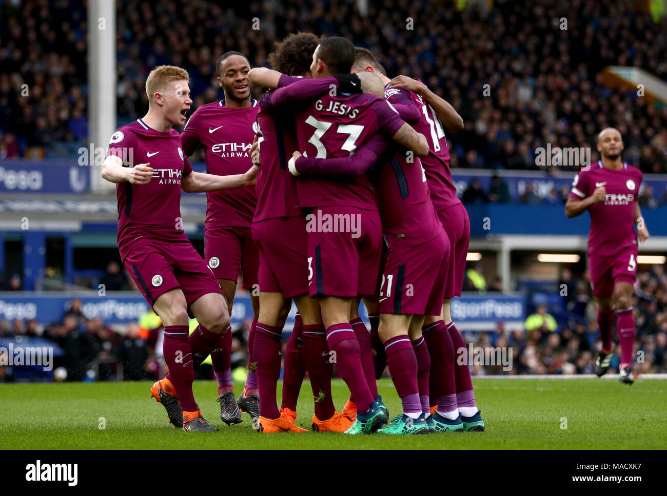 Manchester City's Leroy Sane (centre) celebrates scoring his side's first goal of the game with his team mates during the Premier League match at Goodison Park, Liverpool. Stock Photo