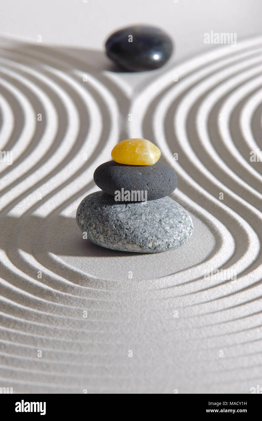 Japanese Zen garden of tranquility with stone in textured sand Stock Photo