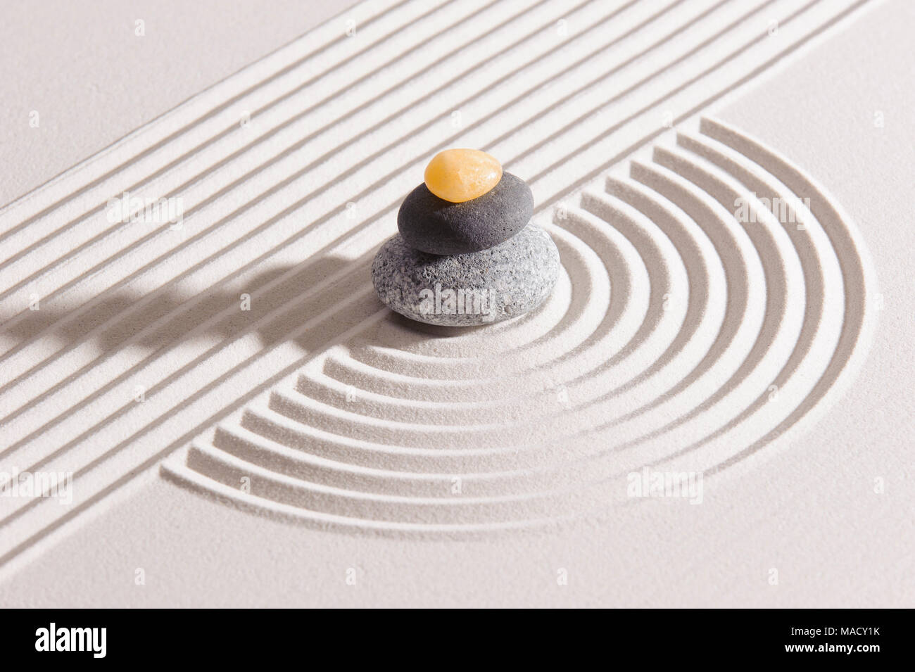 Japanese Zen garden of tranquility with stone in textured sand Stock Photo