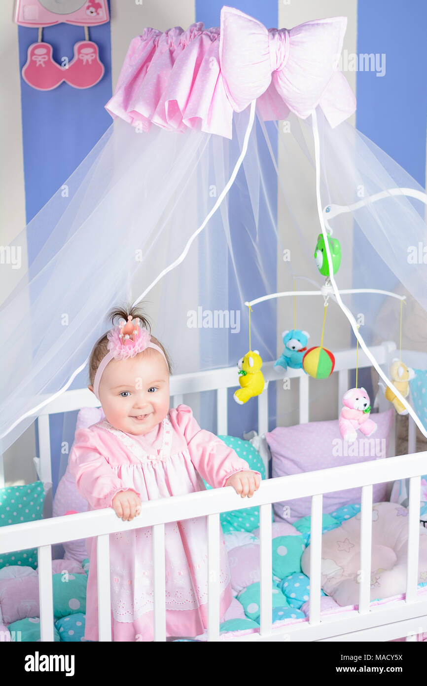 Cute toddler in her crib. Preparing for her midday nap Stock Photo Alamy