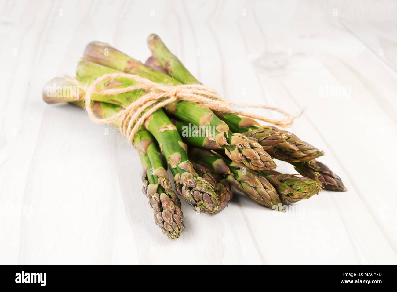 Fresh green asparagus on a white wooden table Stock Photo
