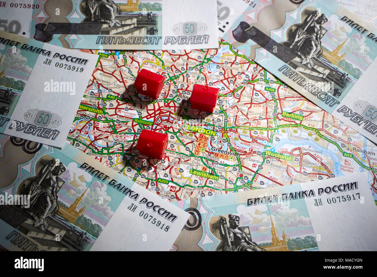 map of london with toy houses and russian ruble currency signifying overseas buyers of property Stock Photo