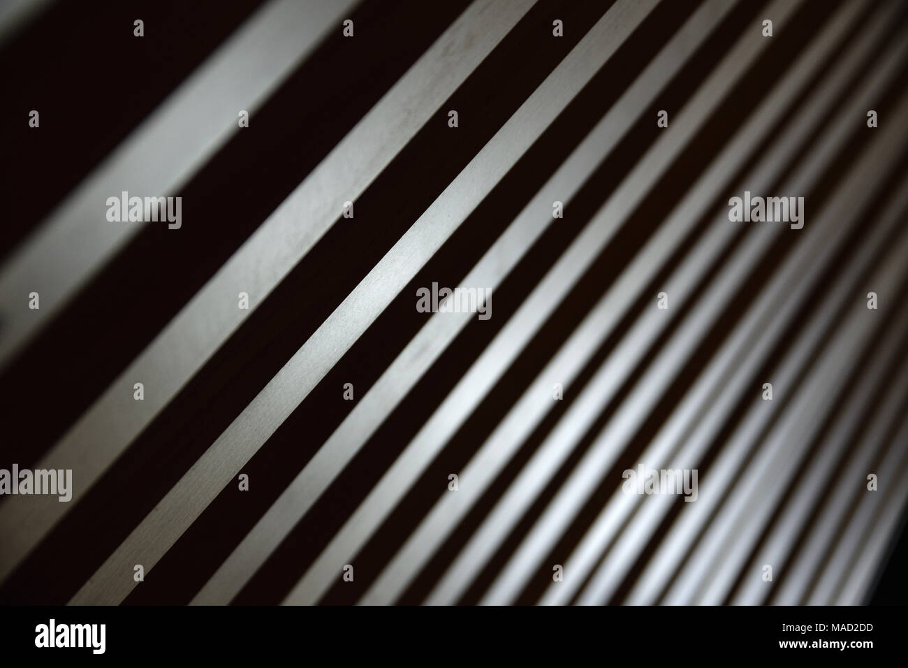 Some parallel lines creating a diagonal background. Low key backdrop. Stock Photo
