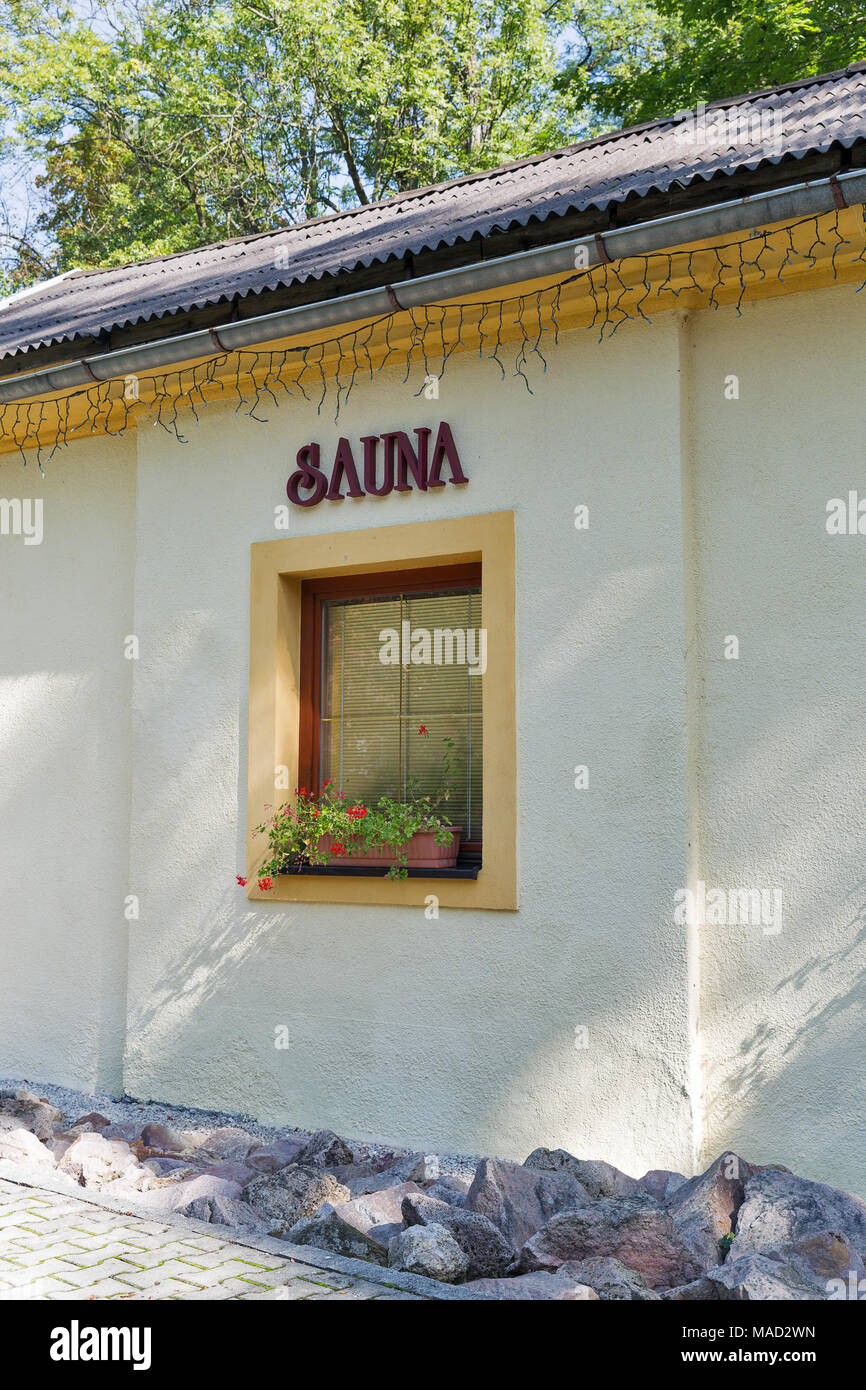 Sauna sign outdoor on building wall with window Stock Photo