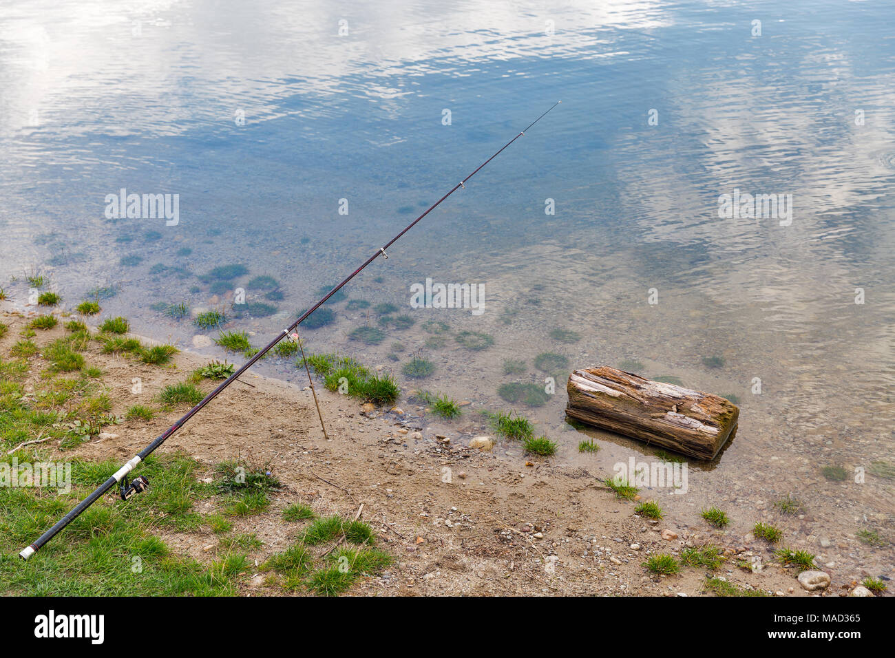A strong diagonal composition of fishing rods and reels at a lakeside Stock  Photo - Alamy