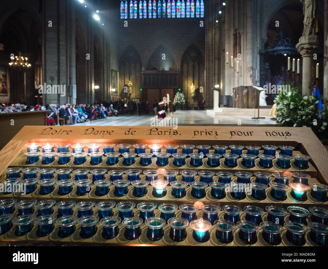 https://c8.alamy.com/comp/MAD8DM/votive-candles-inside-the-notre-dame-cathedral-in-paris-france-MAD8DM.jpg