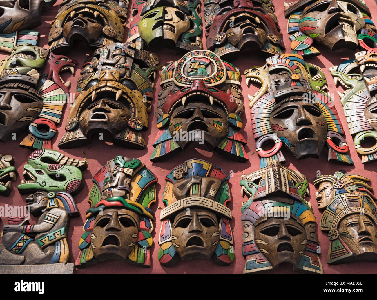 Colored wooden masks at a souvenir stand in Chichen Itza, Yucatan, Mexico Stock Photo