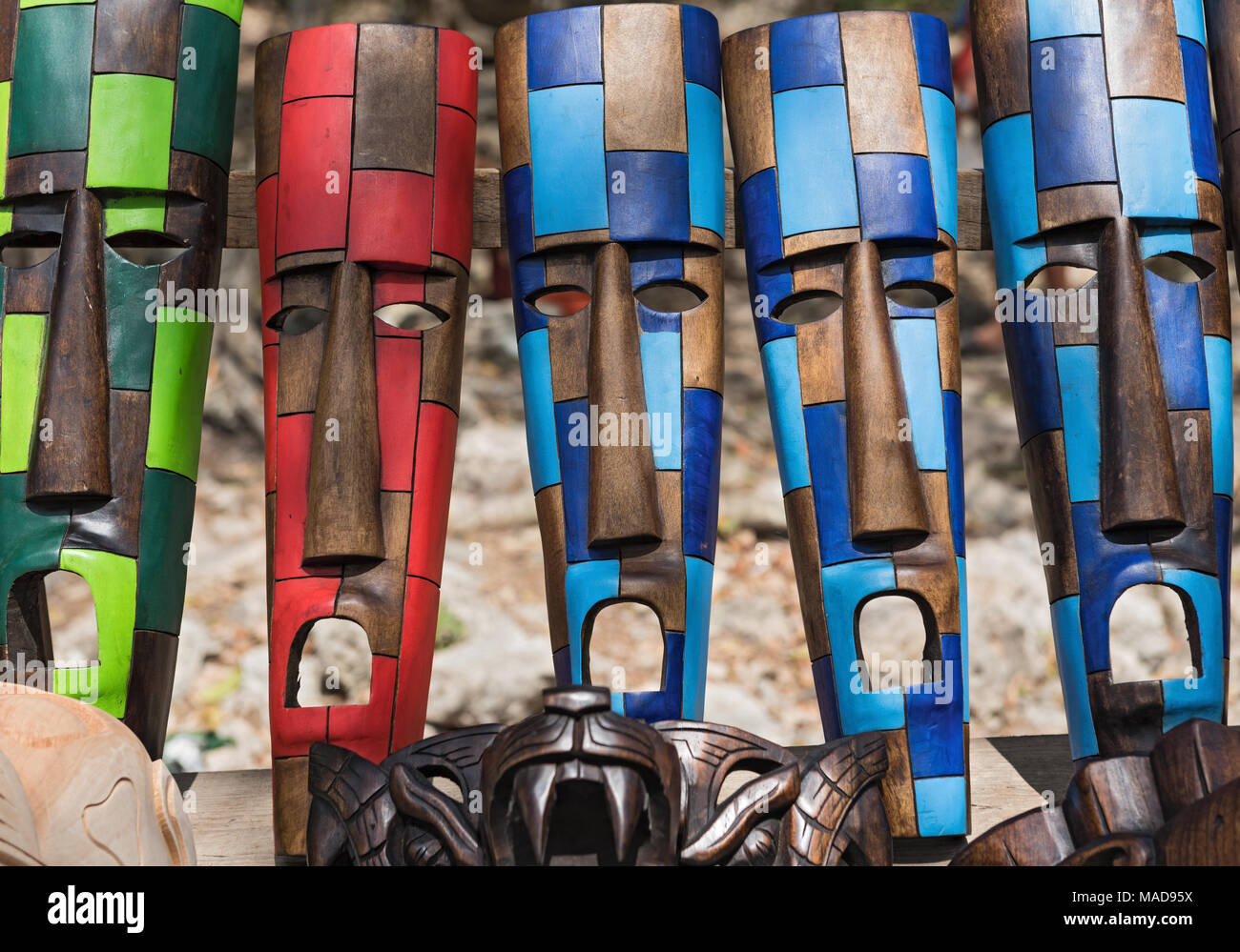 Colored wooden masks at a souvenir stand in Chichen Itza, Yucatan, Mexico Stock Photo