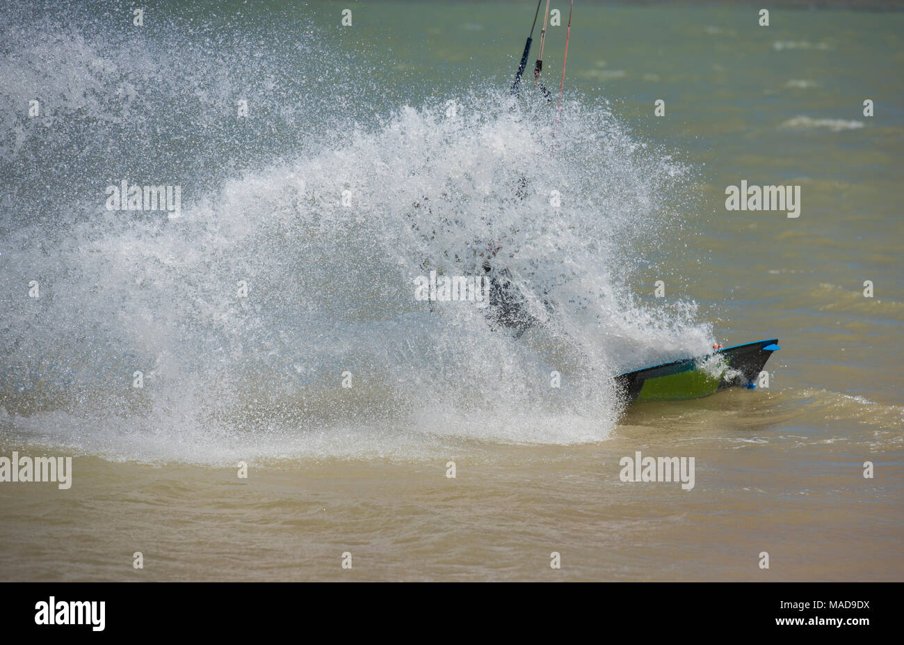 Recreational sport kitesurfer surfing over lagoon in tropcial sea with