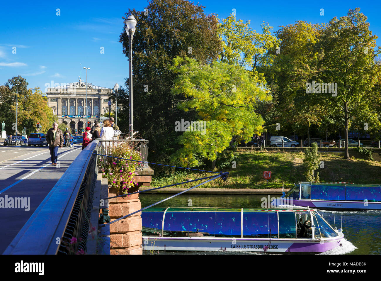 People strolling, Pont d'Auvergne bridge, Ill river, sightseeing boats, University building, Strasbourg, Alsace, France, Europe Stock Photo