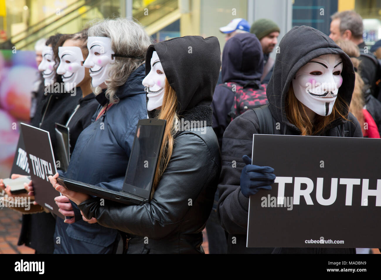 A group of Animal Rights campaigners in Birmingham City Centre, England. The all wore Guy Fawkes type masks and carried placards with the word 'TRUTH' Stock Photo