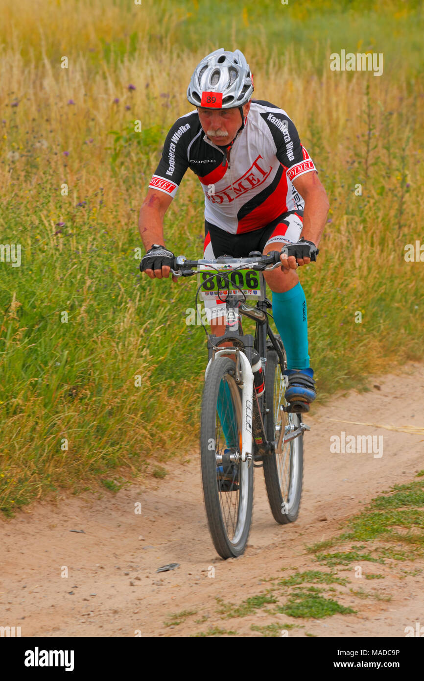 Senior mountain biker riding on a dirty track. MTB Cross Marathon (amateur competition). Kielce, Poland, 26th June 2016. Stock Photo