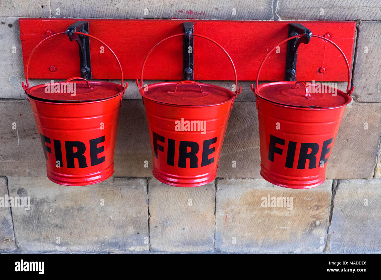 Three red sand buckets in case of fire Stock Photo Alamy