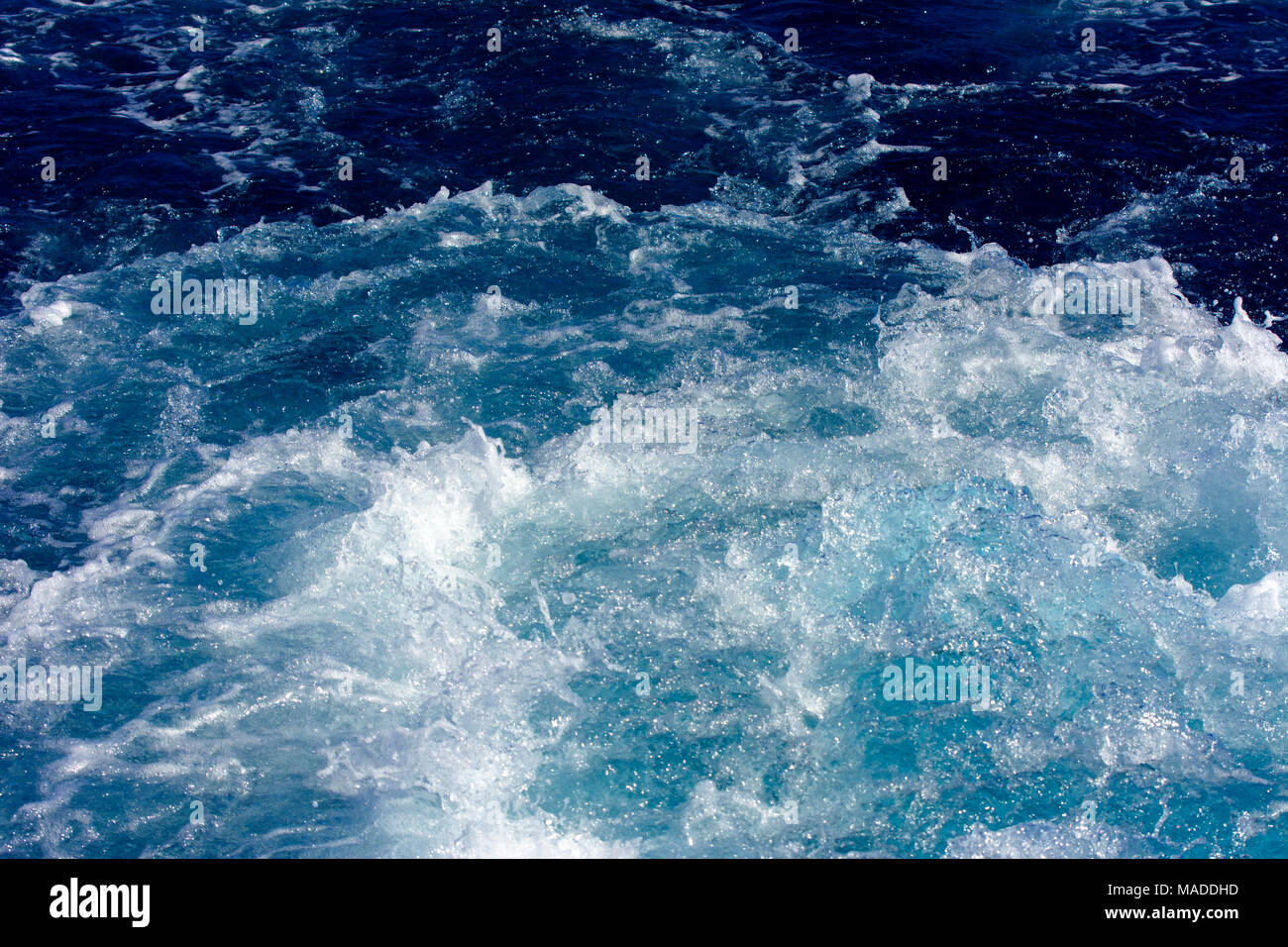 Turbulence made by the foam of sea water from a high-speed yacht on the ...