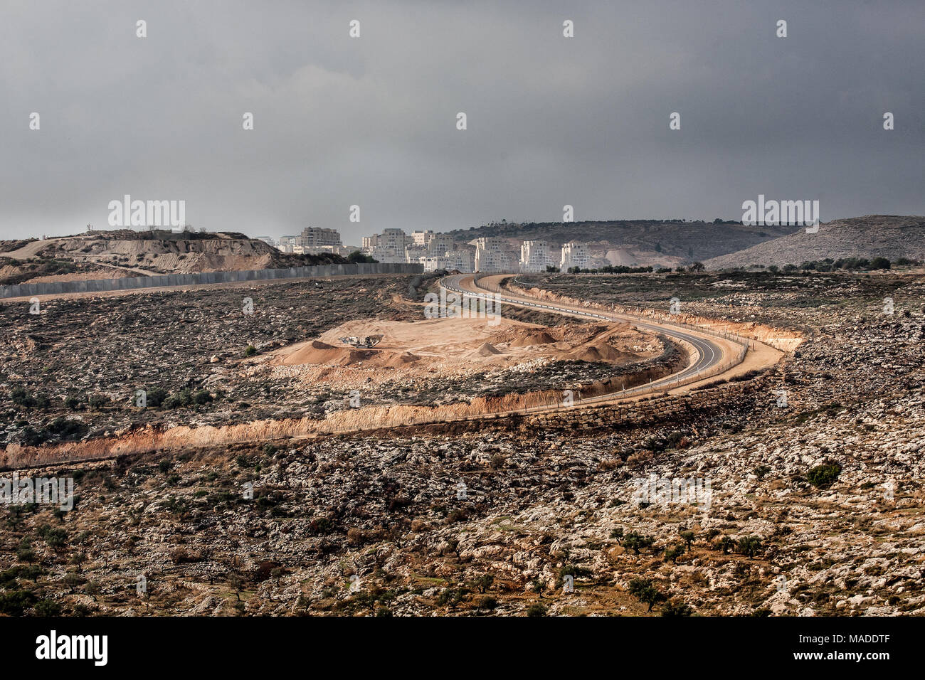 Bilin, Palestine, December 31, 2010: Jewish settlement surrounded by military area built illegally near Palestinian village of Bilin, West Bank. Stock Photo