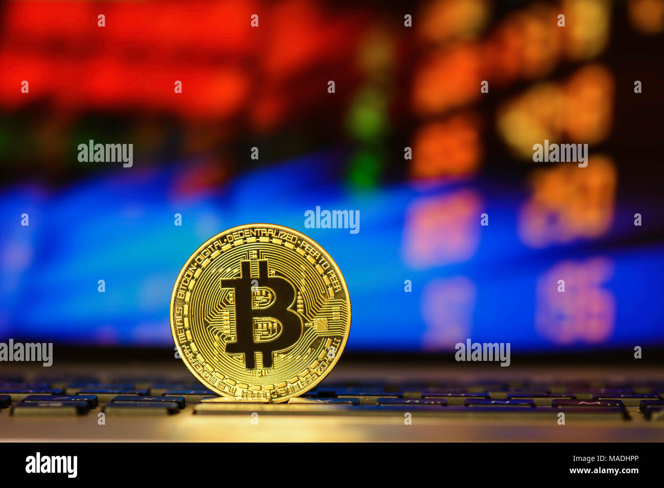 Bitcoin on keyboard against background with blurry graph Stock Photo ...